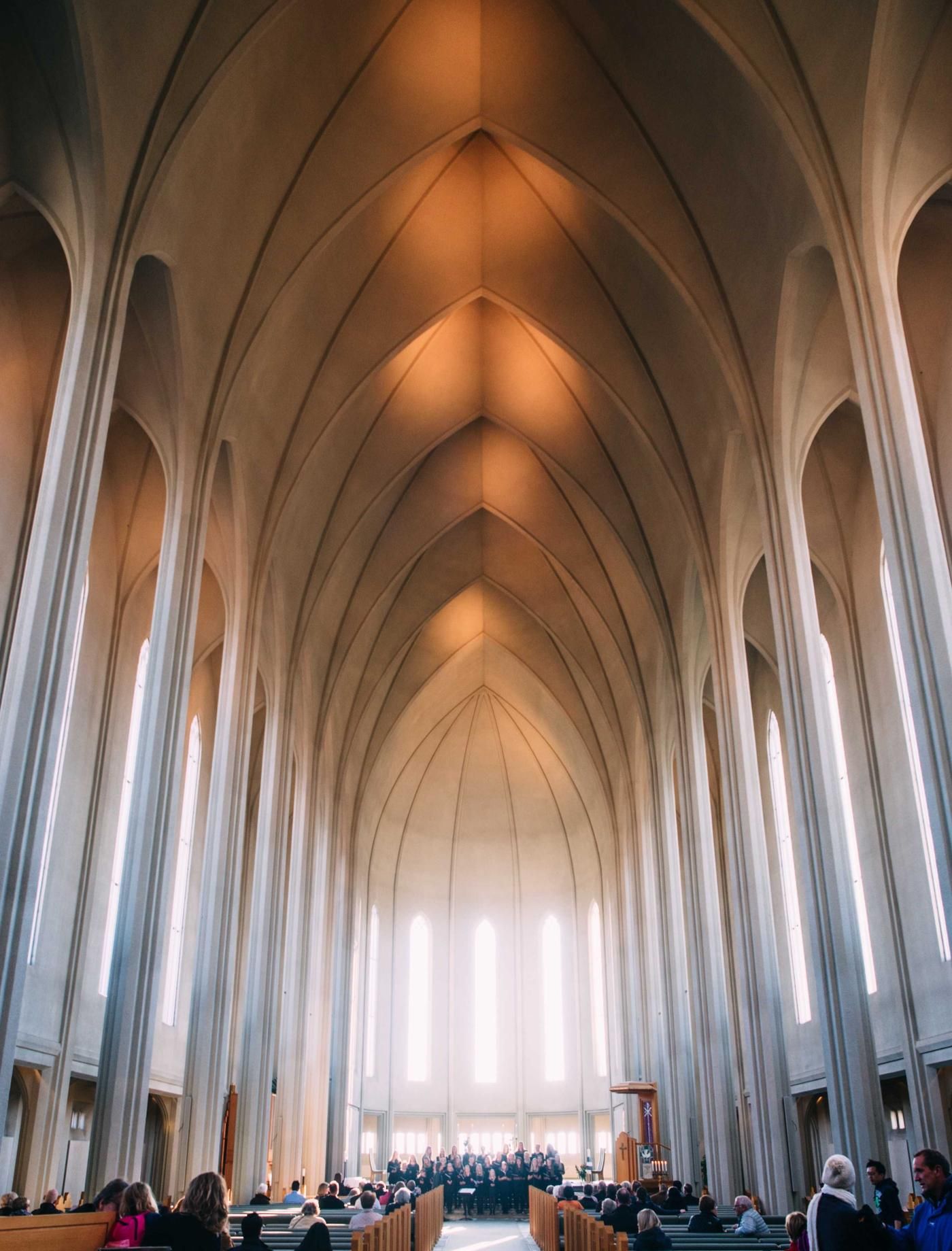 White vaulted arches lit by warm light